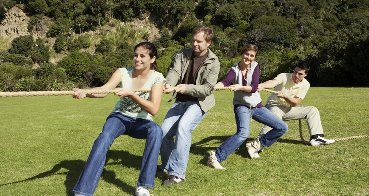 Friends playing tug-of-war in park