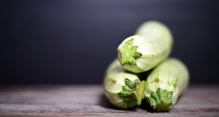 Fresh zucchinis on wood background