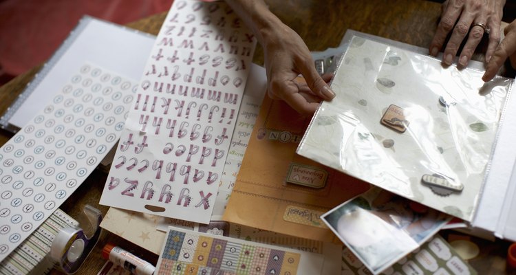 Two women assembling scrapbook, mid section, high angle view