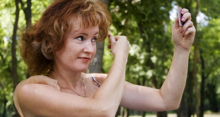 Girl straightens her hair.