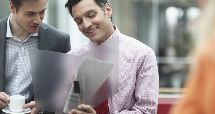 Business colleagues holding files in meeting