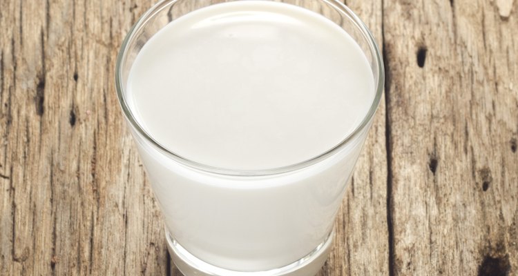 Fresh milk on old wood background