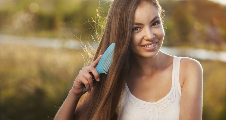 beautiful girl combs her hair Asian appearance