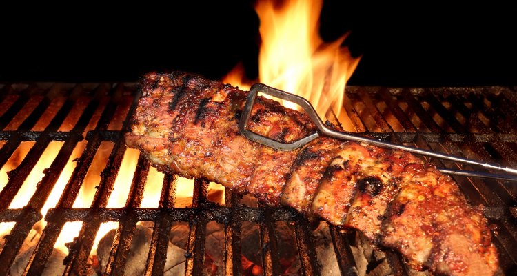 BBQ Roast Baby Back Pork Ribs Close-up On Hot Grill