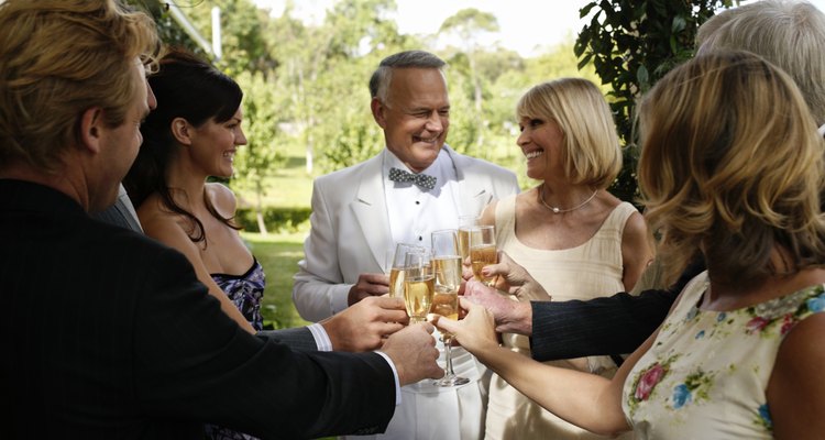 Bride and groom toasting with champagne and guests