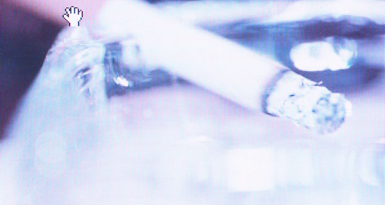 Lit cigarette in ash tray