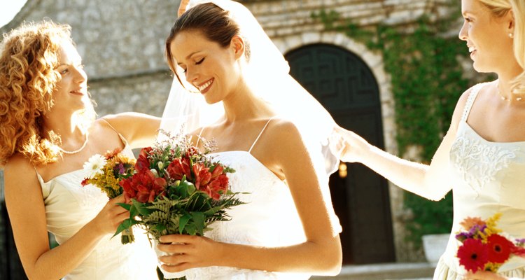 portrait of a bride a two bridesmaid outside a church