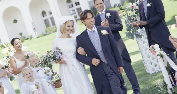 Bride and groom walking up aisle at outdoor wedding