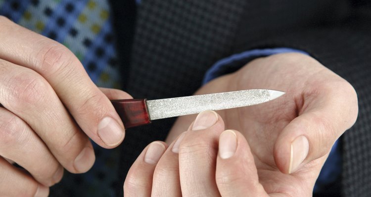 Man filing fingernails