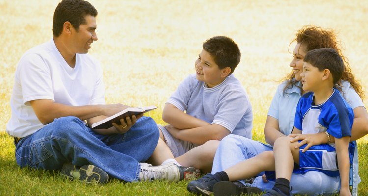 Family listens as father reads a book