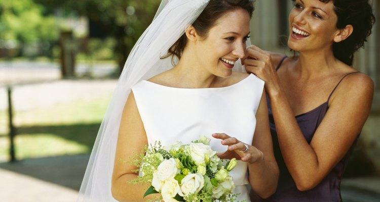 bridesmaid adjusting the bride's veil