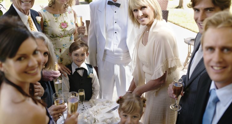 Bride and groom with guests, smiling, portrait