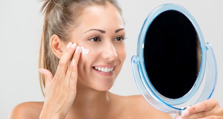 Young Woman Putting Face Cream