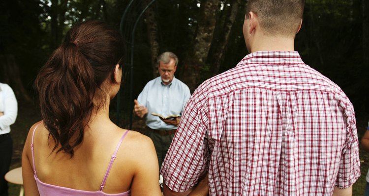 Couple with Priest Rehearsing for the Wedding