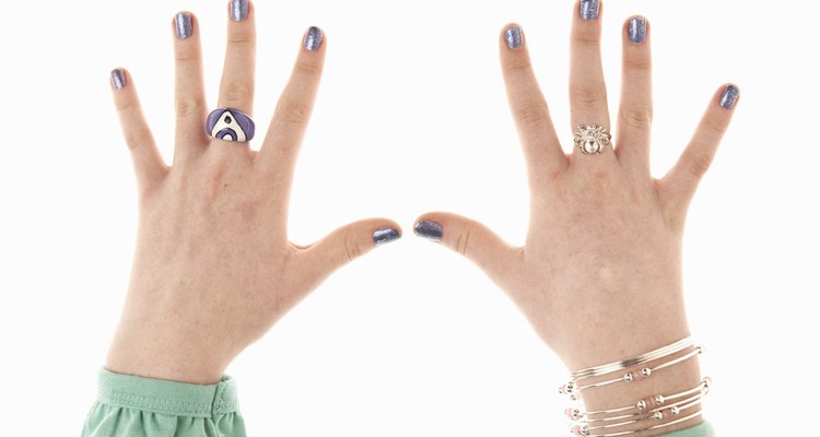 Teenage girl (14-16) wearing rings and bracelets, close-up of hands
