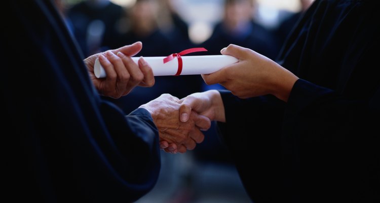 Graduate receiving a diploma, close-up of hands