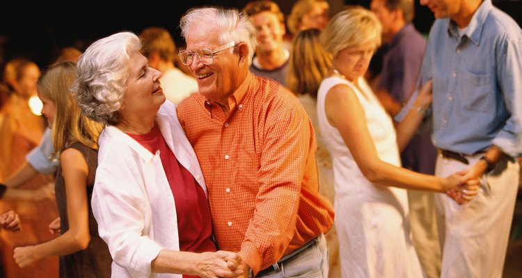 Man and woman dancing among a group of people