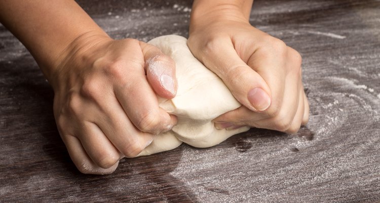 Baking preparing background. Female hands kneading dough