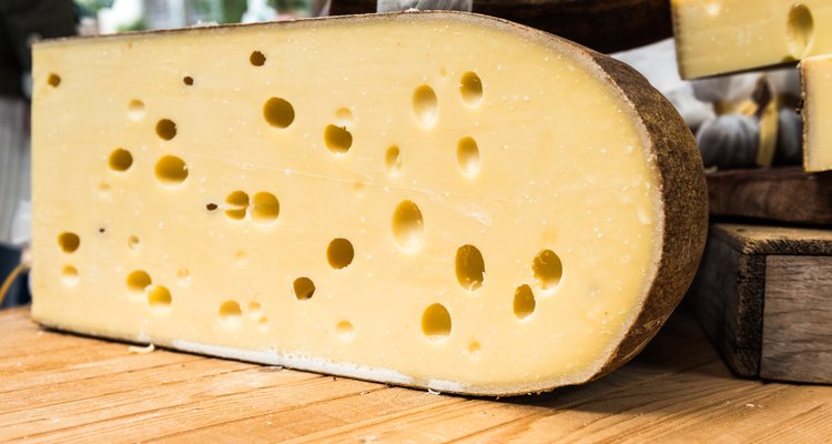 Quarter of Emmental cheese head on the market place. Close-up