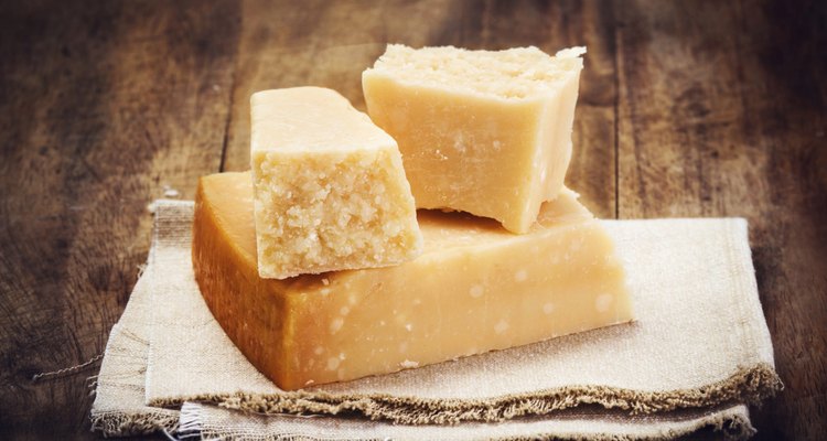 Italian Parmesan Cheese on Wooden Background close up.