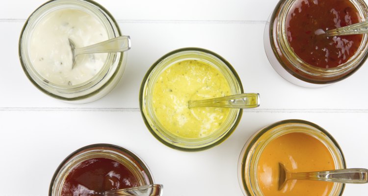 five jars filled with all kind of sauces