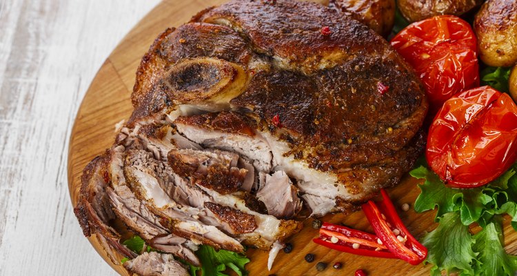 roasted pork shoulder on the bone with potatoes